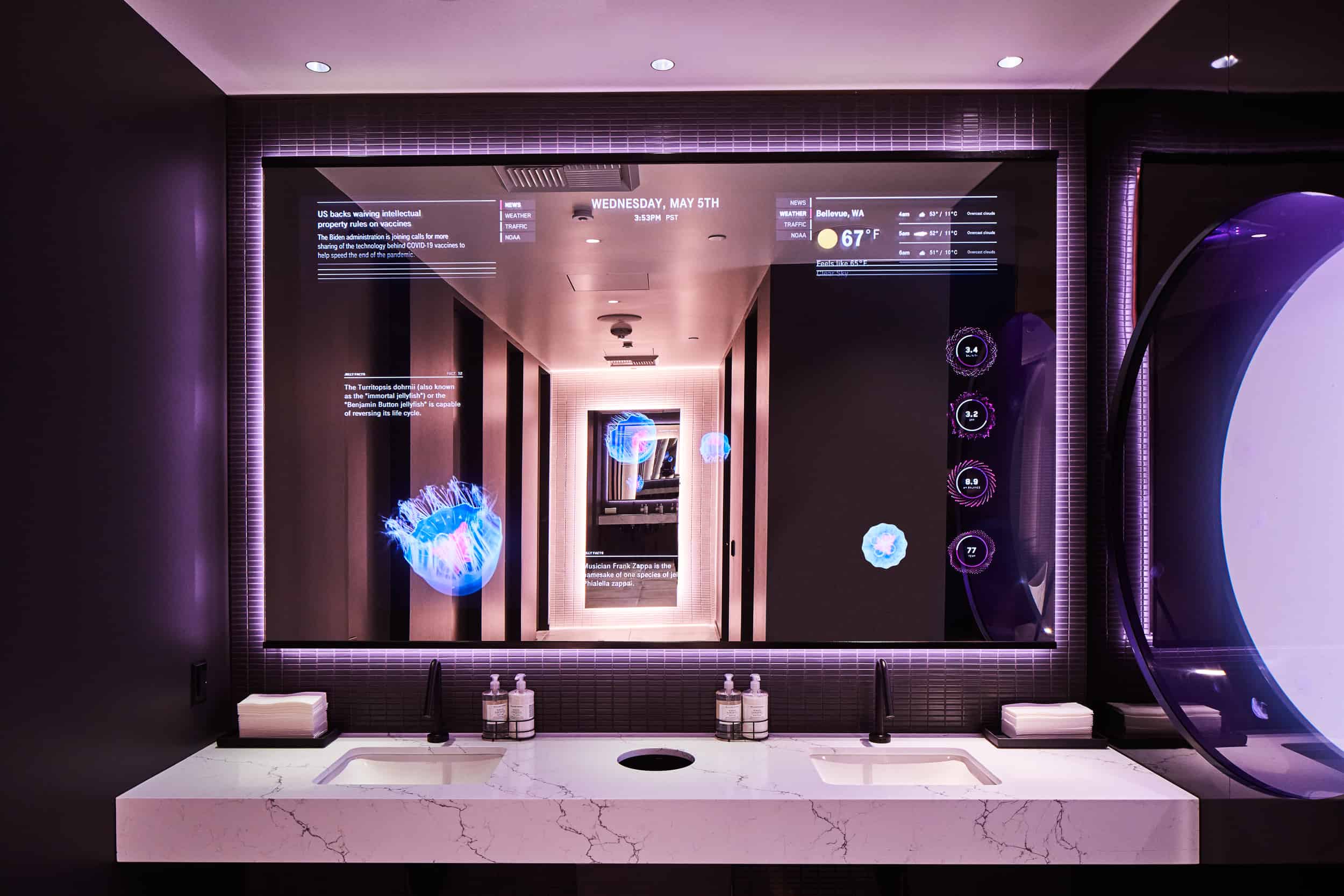 Futuristic bathroom: smart mirror with weather/date/icons, black faucets, white sinks, purple-lit marble countertops.