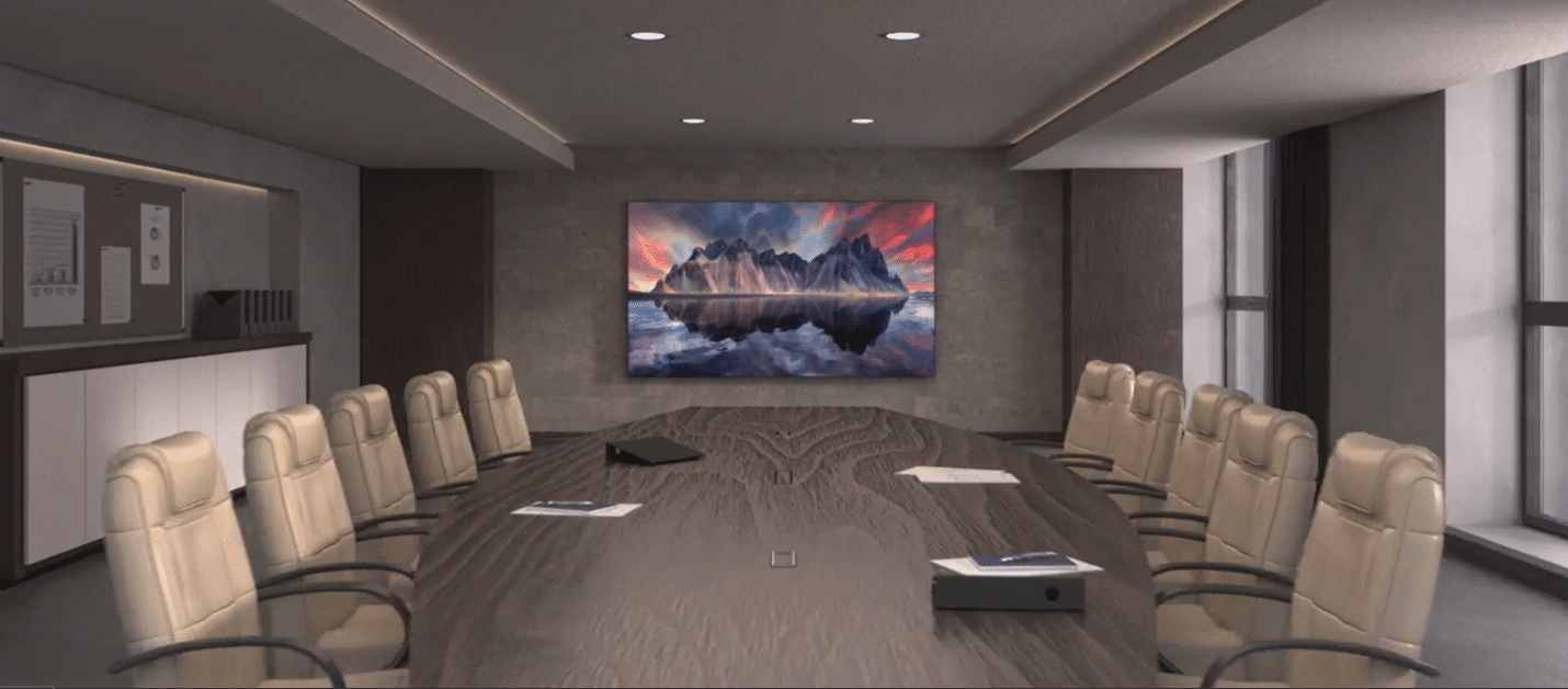 Modern conference room with oval table, beige chairs, Samsung display, and bright natural light from large windows.